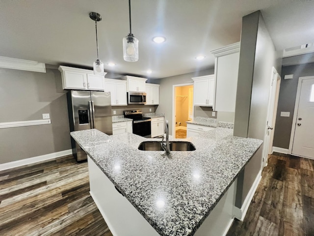 kitchen with white cabinetry, stainless steel appliances, dark hardwood / wood-style floors, light stone counters, and decorative light fixtures