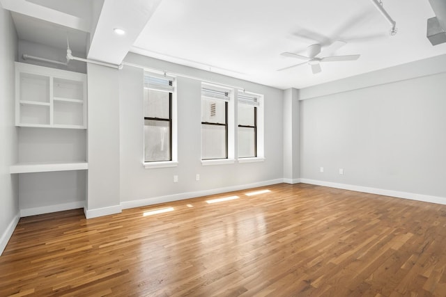 spare room featuring ceiling fan and hardwood / wood-style flooring