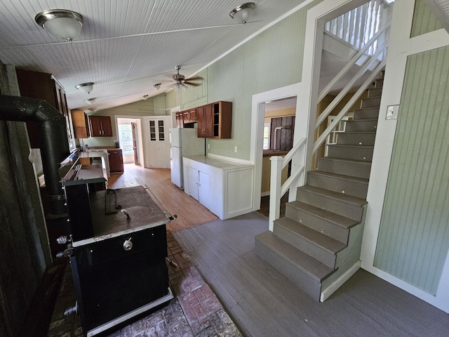 kitchen featuring ceiling fan, white refrigerator, and vaulted ceiling