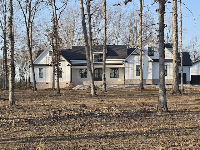 view of front of house featuring board and batten siding and crawl space