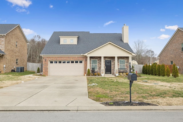 view of front of home with covered porch, a garage, central AC, and a front lawn