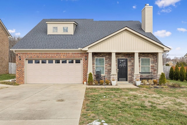 view of front of house with covered porch, a garage, and a front lawn