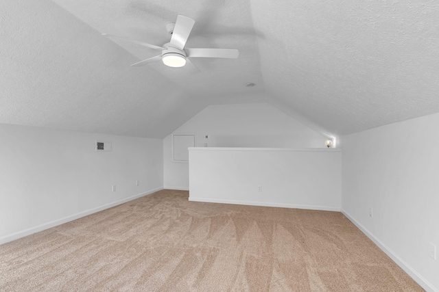 bonus room with ceiling fan, a textured ceiling, and lofted ceiling