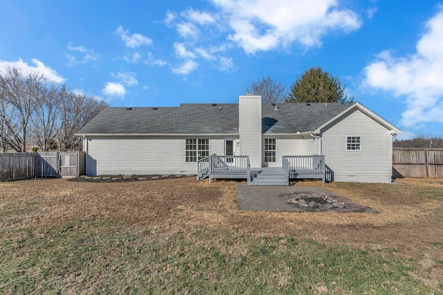 back of house with a wooden deck and a yard