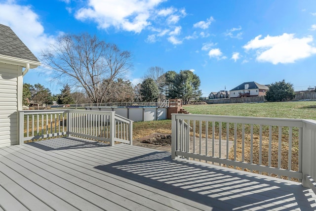 wooden terrace featuring a yard