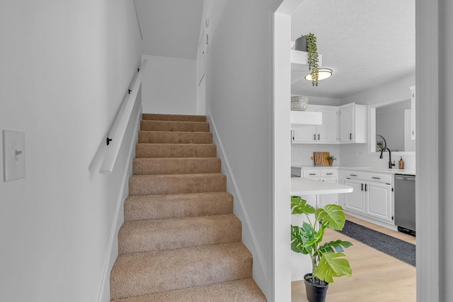 stairway with a textured ceiling