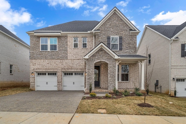 view of front of house with a garage and a front yard