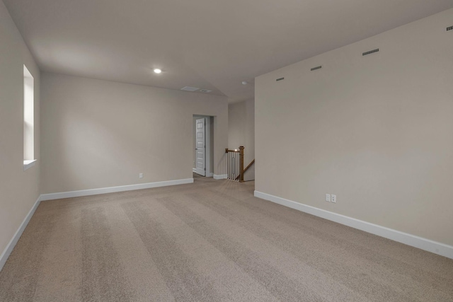 unfurnished room featuring light carpet