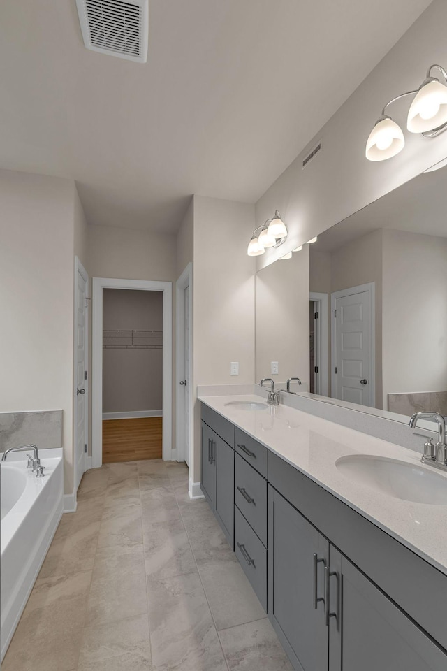 bathroom with vanity and a bath