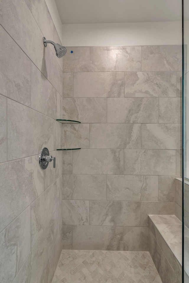 bathroom with tiled shower