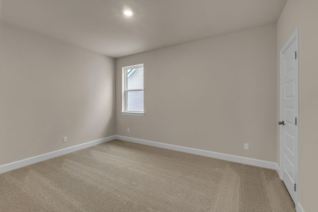 spare room with light colored carpet