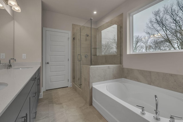 bathroom with vanity and separate shower and tub