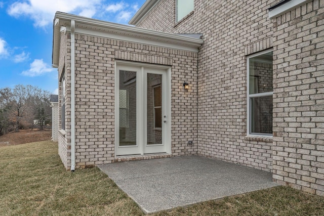 doorway to property with a yard, a patio area, and french doors