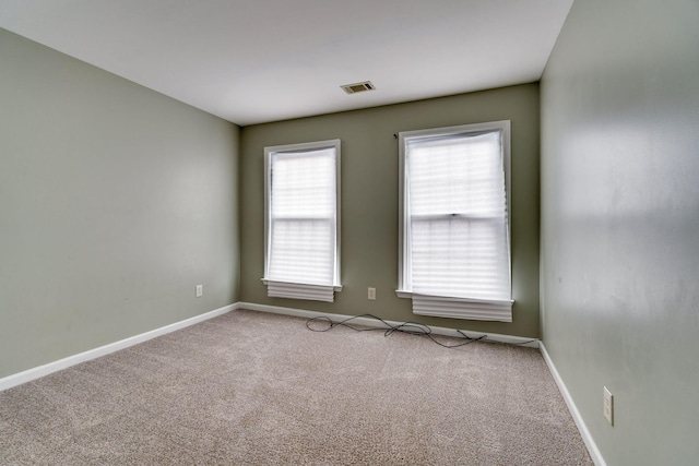 unfurnished room with light carpet