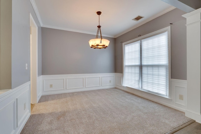 spare room featuring light colored carpet, a wealth of natural light, and ornamental molding