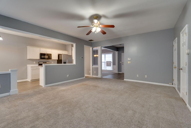 unfurnished living room featuring light carpet and ceiling fan