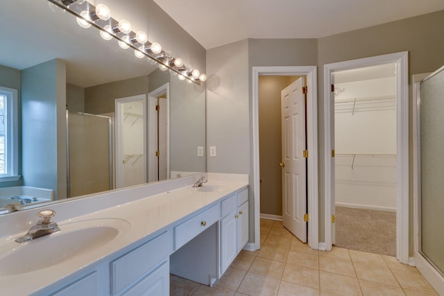 bathroom featuring tile patterned flooring, vanity, and independent shower and bath