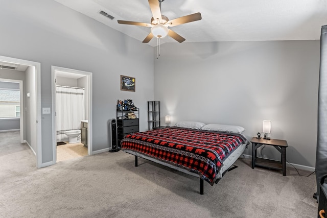 carpeted bedroom featuring ensuite bath, ceiling fan, and high vaulted ceiling