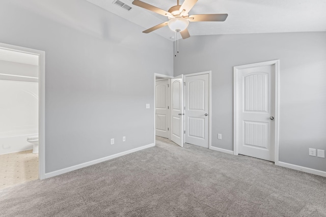 unfurnished bedroom featuring light carpet, high vaulted ceiling, ensuite bath, and ceiling fan