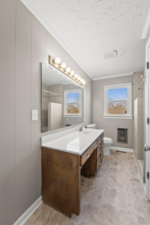 bathroom featuring a textured ceiling, vanity, a shower, toilet, and crown molding