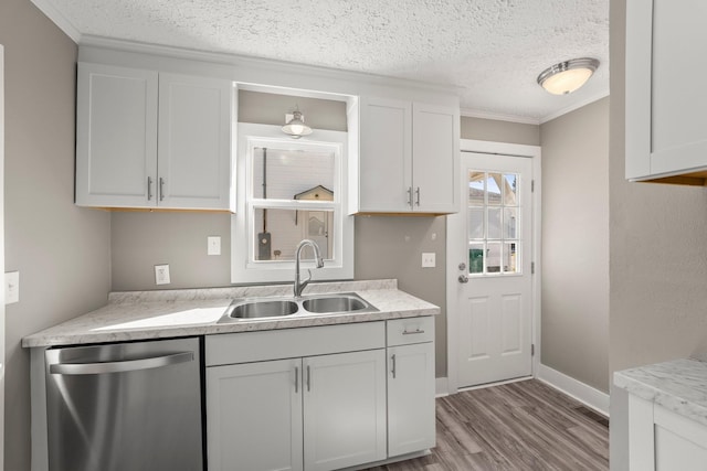 kitchen with white cabinets, dishwasher, sink, and ornamental molding