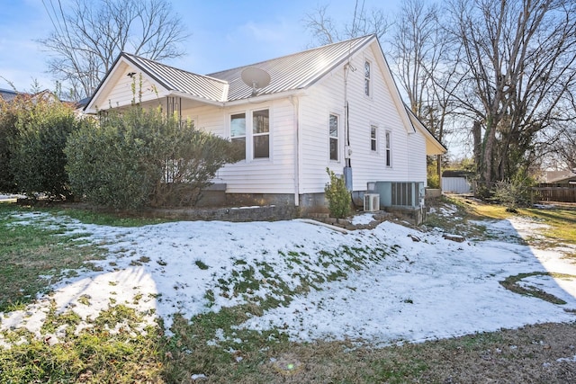 view of snowy exterior with central AC