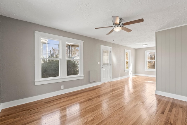 interior space featuring a textured ceiling, ceiling fan, and wood-type flooring