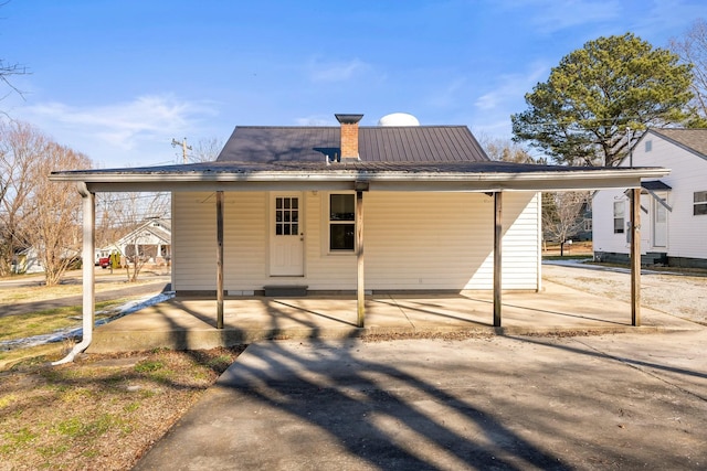 rear view of house featuring a carport