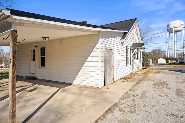 view of side of property with a carport