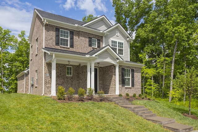 craftsman-style home with a front lawn and a porch