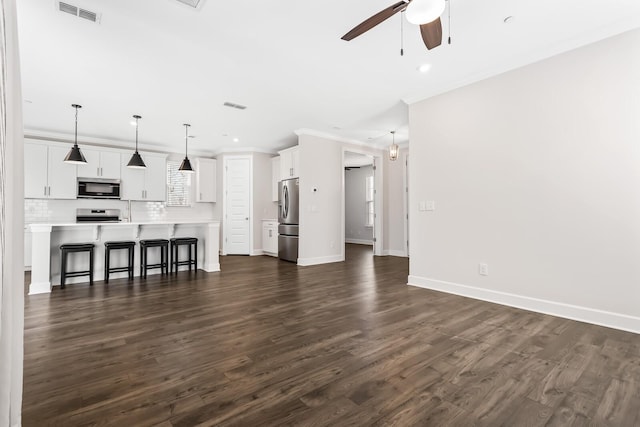 unfurnished living room featuring dark wood-style floors, visible vents, crown molding, and ceiling fan