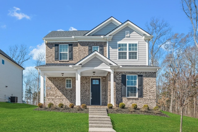 craftsman-style home with central air condition unit, a shingled roof, a front lawn, and brick siding