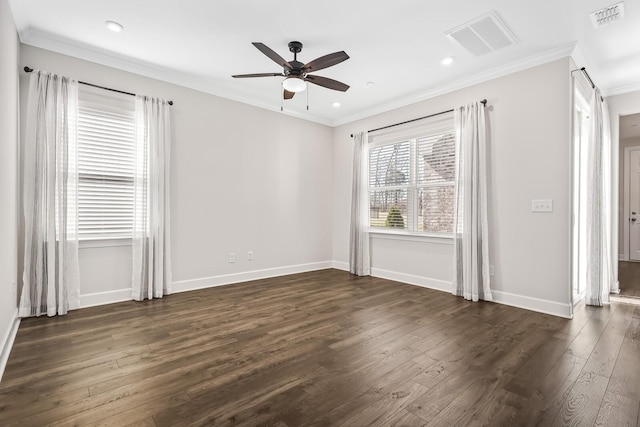 spare room featuring baseboards, crown molding, visible vents, and dark wood-type flooring