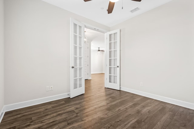 empty room with french doors, dark wood-style flooring, visible vents, and baseboards