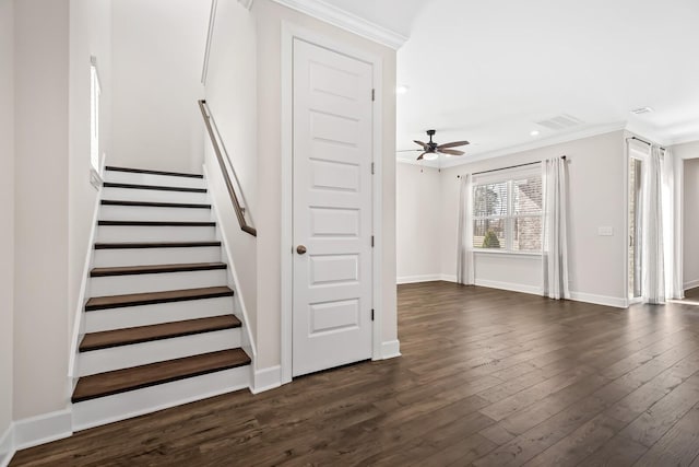 stairway featuring visible vents, ornamental molding, a ceiling fan, wood finished floors, and baseboards