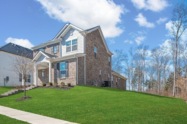 craftsman-style house featuring brick siding, a front lawn, and central air condition unit