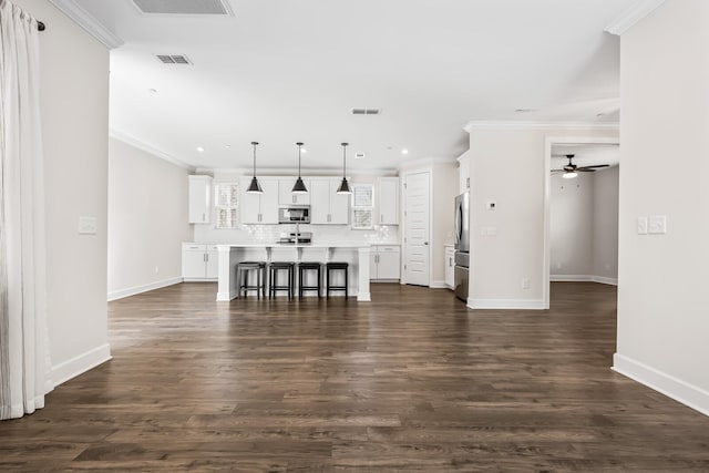 living area with ceiling fan, dark wood finished floors, visible vents, and crown molding