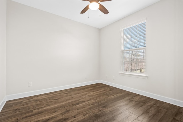 empty room featuring ceiling fan, dark wood finished floors, and baseboards