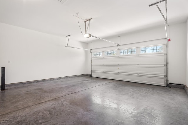 garage featuring baseboards and a garage door opener