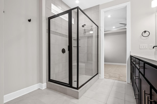 bathroom featuring a stall shower, a sink, baseboards, and recessed lighting