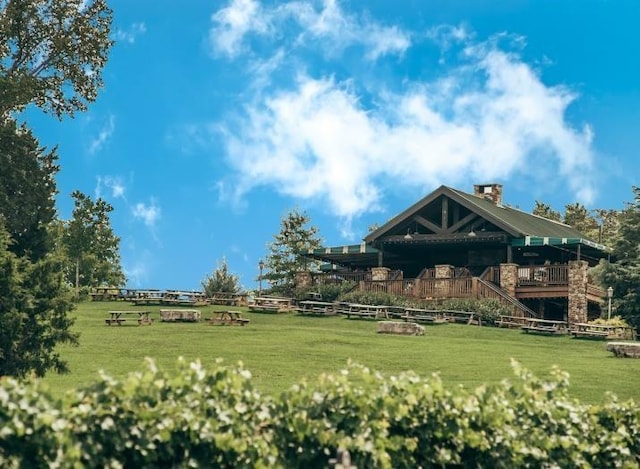 view of community featuring a yard and stairs