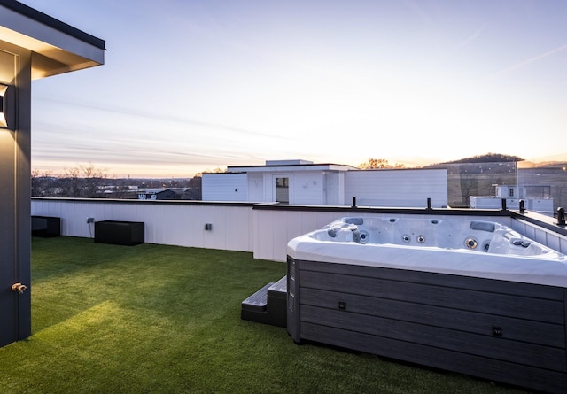 yard at dusk with a hot tub