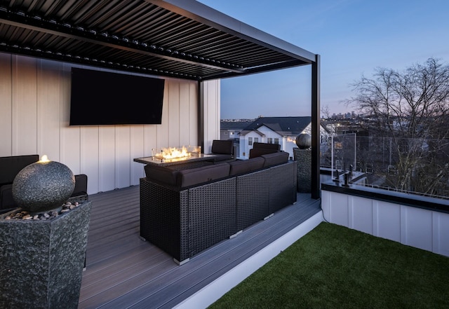 wooden deck featuring an outdoor living space with a fire pit