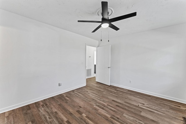 unfurnished room with ceiling fan and dark hardwood / wood-style flooring