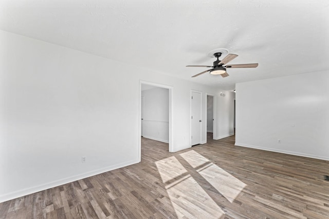 empty room featuring ceiling fan and wood-type flooring