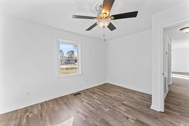 spare room with a textured ceiling, ceiling fan, and hardwood / wood-style floors