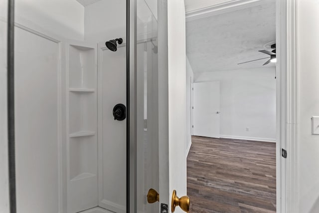 bathroom with walk in shower, wood-type flooring, a textured ceiling, and ceiling fan