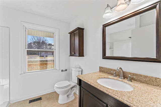 bathroom featuring toilet, vanity, and tile patterned flooring