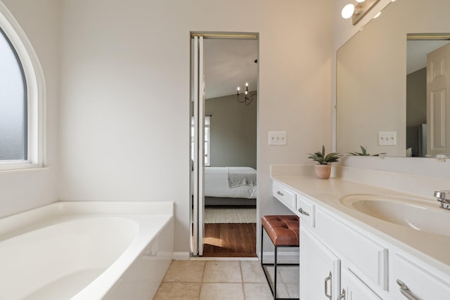 bathroom featuring a washtub, vanity, and tile patterned floors