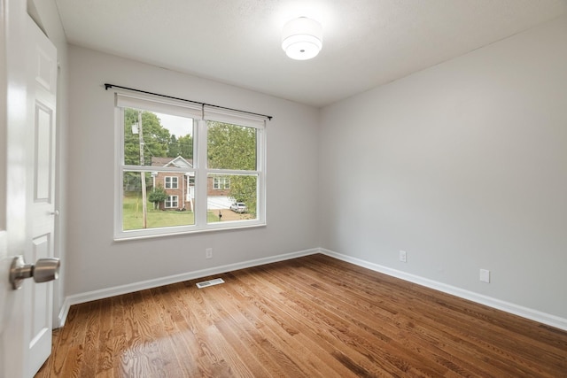 spare room featuring hardwood / wood-style floors